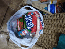 a bag filled with a variety of items including a can of diet coke and a bag of bush 's tortas