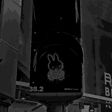 a black and white photo of a traffic light with a bunny and the number 38.2 on it