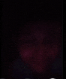 a dark purple background with a few spots of light on it