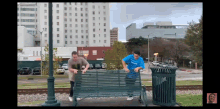 a man in a blue shirt that says ' i love you ' on it is standing on a bench