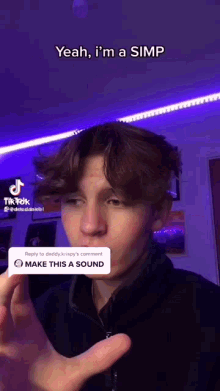 a young man is making a funny face while talking to someone on a tiktok video .