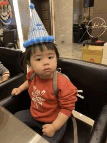 a little boy wearing a party hat that says prince on it