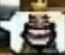 a blurred image of a person 's face with a crown on top of it .