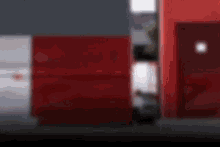 a blurry picture of a red wall with a door