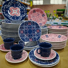 a set of blue and pink plates and cups