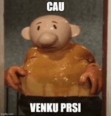 a cartoon character is standing in a doorway with a caption that says cau venku prsi .