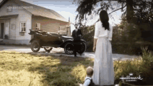 a woman in a white dress is standing next to a man in a suit in front of an old car ..