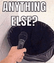 a person holding a microphone in front of a trash can that says " anything else "