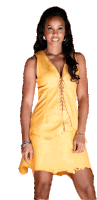 a woman in a yellow dress is smiling and looking at the camera