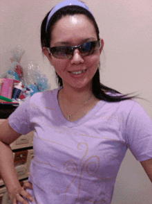 a woman wearing sunglasses and a purple shirt that has the word coffee on it