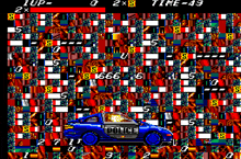 a video game screen shows a blue police car driving through a checkered pattern