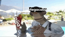 a man in a suit and tie is sitting at a table with a drink in front of a pool .