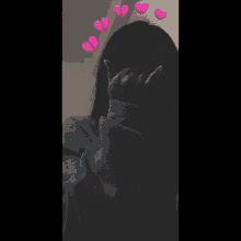 a girl making a heart shape with her hands with broken hearts around her head