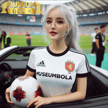 a woman holding a soccer ball wearing an adidas museumbola shirt