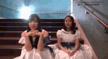 two girls are sitting on a set of stairs with the words morning musume '17 dvd magazine above them