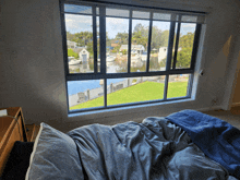 a bed in front of a window with a view of the water