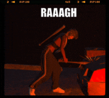 a woman with a bat is standing in front of a car with the word raaagh on the top