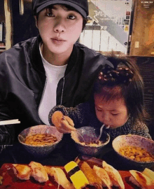 a boy and a little girl are sitting at a table eating food