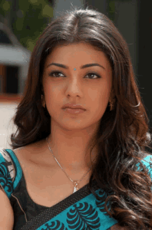 a close up of a woman 's face wearing a necklace