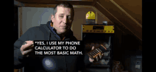 a man holding a calculator that says " yes , i use my phone calculator to do the most basic math "