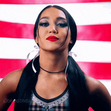 a woman stands in front of a red white and blue striped background with the words " womens division " below her