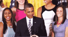 a man in a suit and tie stands in front of a podium with a united states of america emblem on it