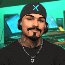 a man with a beard wearing headphones and a beanie with a blue x on it