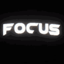 the word focus is lit up in white on a dark background