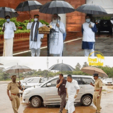 a group of men holding umbrellas in front of a building that has the word kerala on it