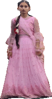 a woman in a pink dress with a braid is standing on a white background .