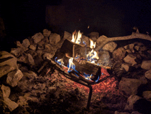 a pile of logs is burning in a fireplace