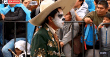 a man in a cowboy hat is standing in front of a crowd with a cdmx logo on the bottom