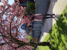 a woman in a red hat is standing on a sidewalk in front of a blue house