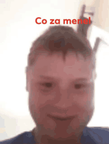 a close up of a boy 's face with the words co za menel written in red