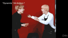 two men are hugging each other in front of a red background and the words dynamite 1m dislikes are on the bottom