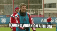 a group of soccer players are standing on a field with a sign that says " leaving work on a friday "