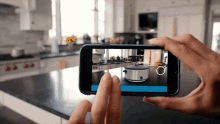 a person taking a picture of a kitchen with their phone