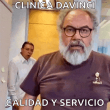 a man with a beard and glasses is wearing a clinica davinci quality y servicio shirt