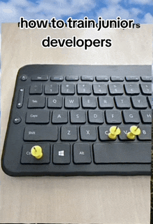 a picture of a keyboard with the words " how to train juniors developers " on it