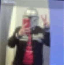 a blurry picture of a person taking a selfie with a cell phone