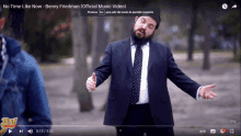 a video of a man in a suit and tie is titled no time like now by benny friedman