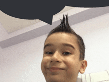 a young boy with a mohawk and a speech bubble above his head