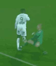 a soccer player with the number 9 on his jersey is kicking the ball