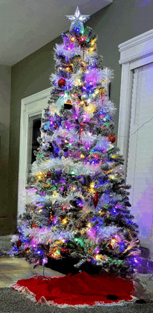 a christmas tree with a star on top is sitting in a living room