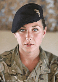 a woman in a military uniform has the name alison bakerville on her badge