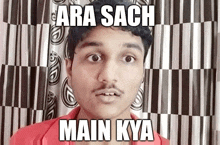 a man with a mustache is standing in front of a checkered curtain with a caption that says ara sach main kya