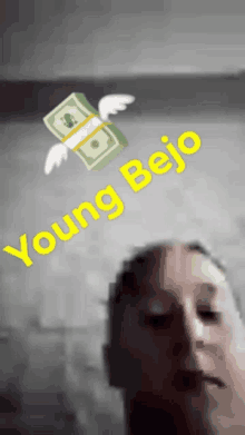 a person 's face is behind a stack of money that says young beijo on it