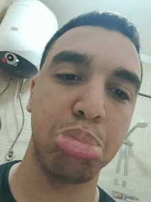 a man is making a funny face in front of a heater