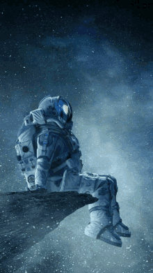 an astronaut is sitting on a rock looking at the stars