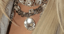 a close up of a woman 's neck with a necklace and earrings